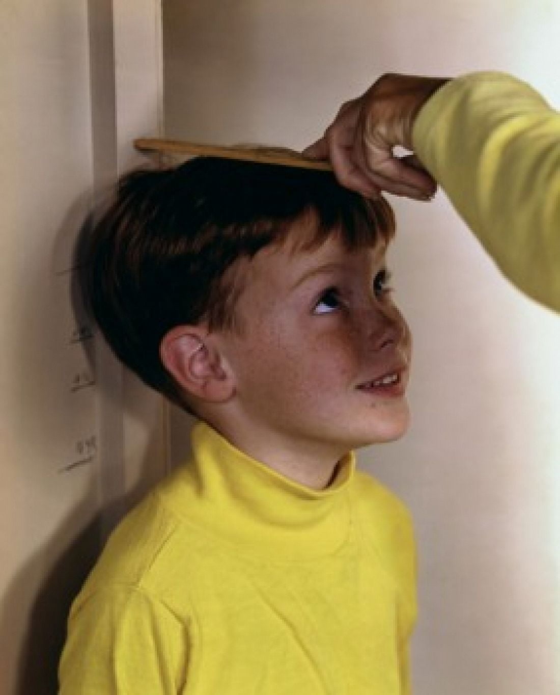 Boy being measured Canvas Art - (18 x 24)