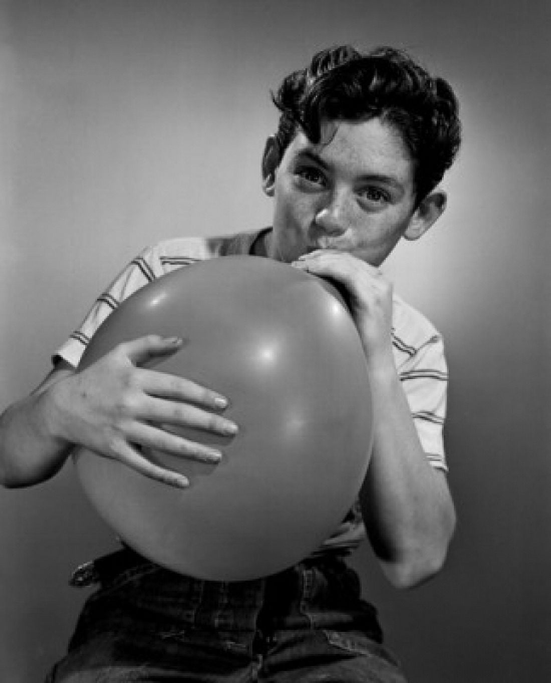Boy blowing balloon Canvas Art - (24 x 36)