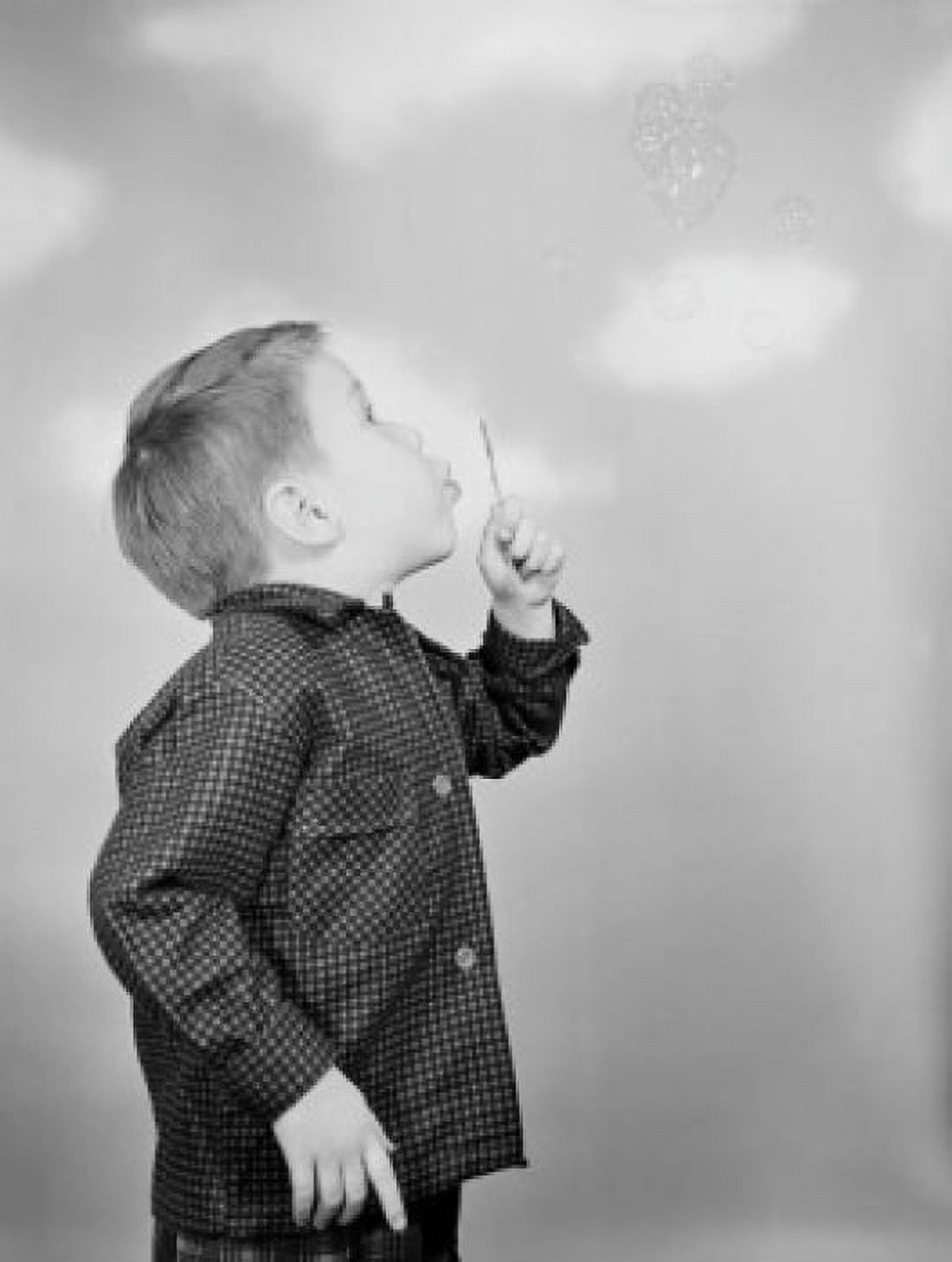 Boy blowing bubbles Canvas Art - (24 x 36)