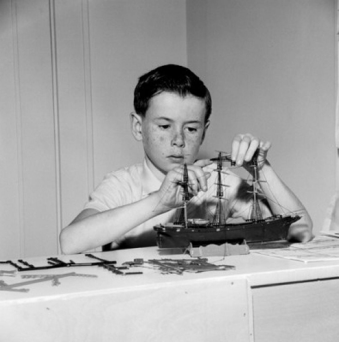 Boy building ship model Canvas Art - (18 x 24)