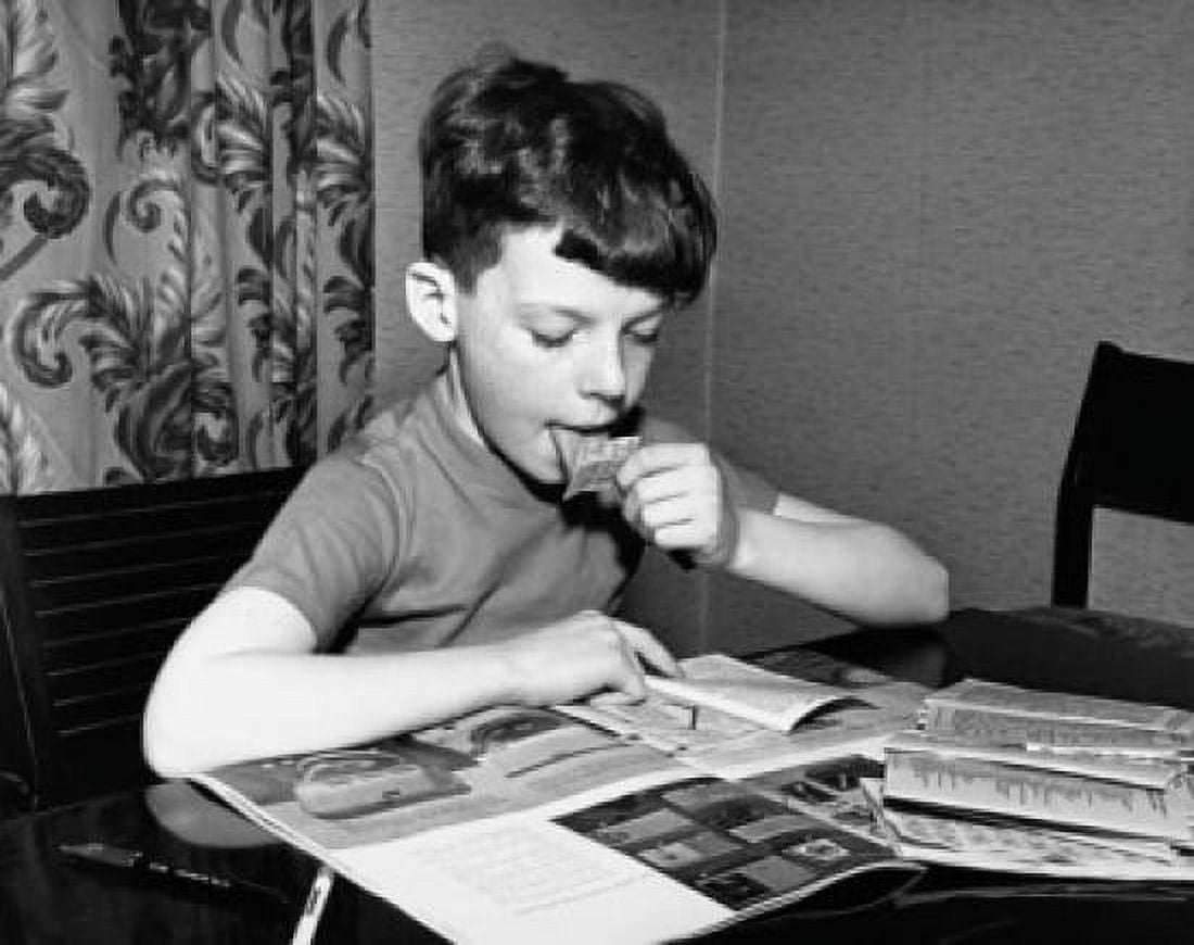 Boy collecting trading stamps Canvas Art - (24 x 36)