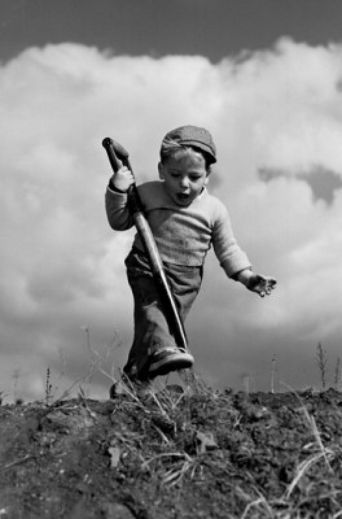 Boy digging and looking surprised Canvas Art - (18 x 24)