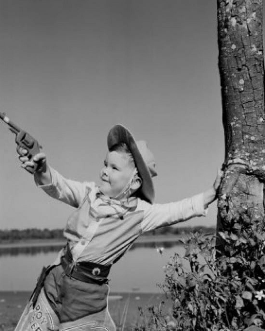 Boy dressed as cowboy playing with toy gun Canvas Art - (18 x 24)