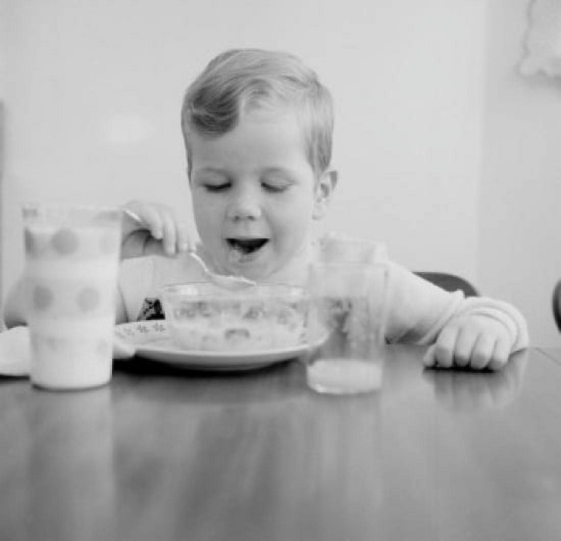 Boy eating breakfast cereal Canvas Art - (18 x 24)