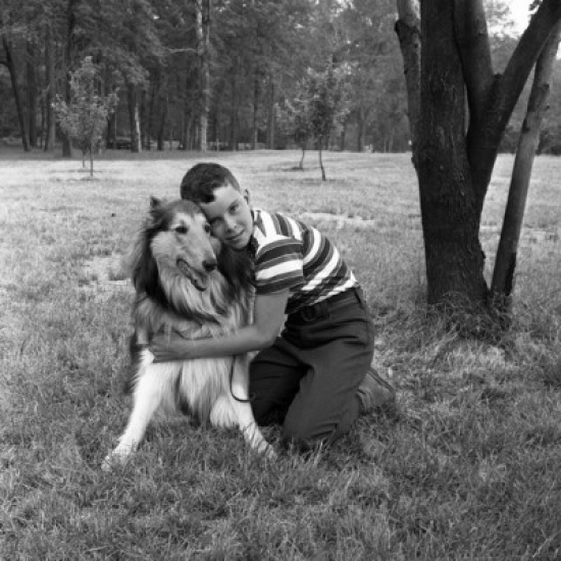 Boy embracing dog on grass Canvas Art - (18 x 24)