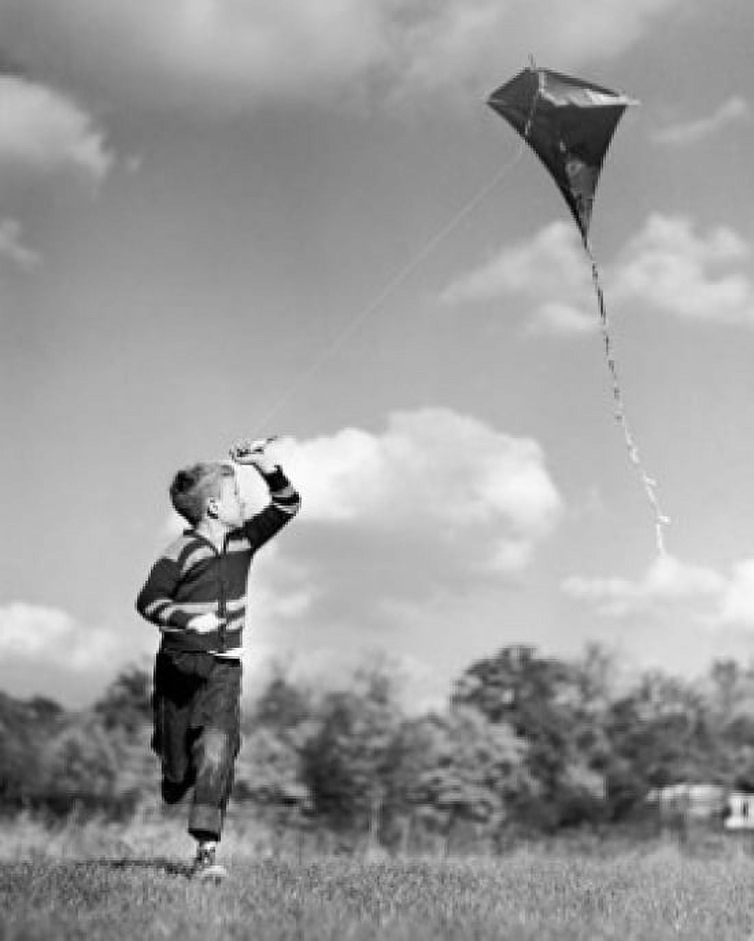 Boy flying a kite in a field Canvas Art - (18 x 24)
