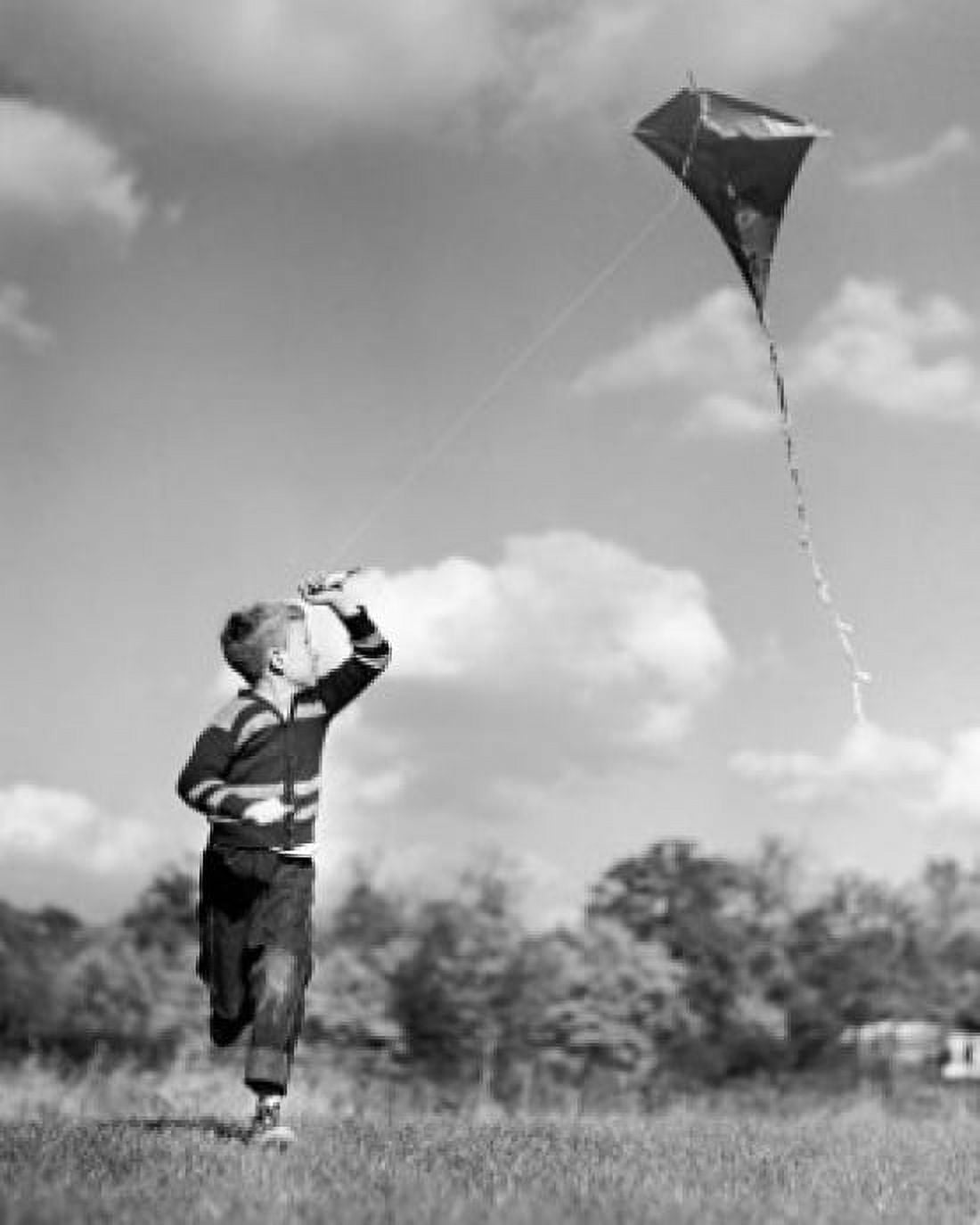 Boy flying a kite in a field Canvas Art - (24 x 36)