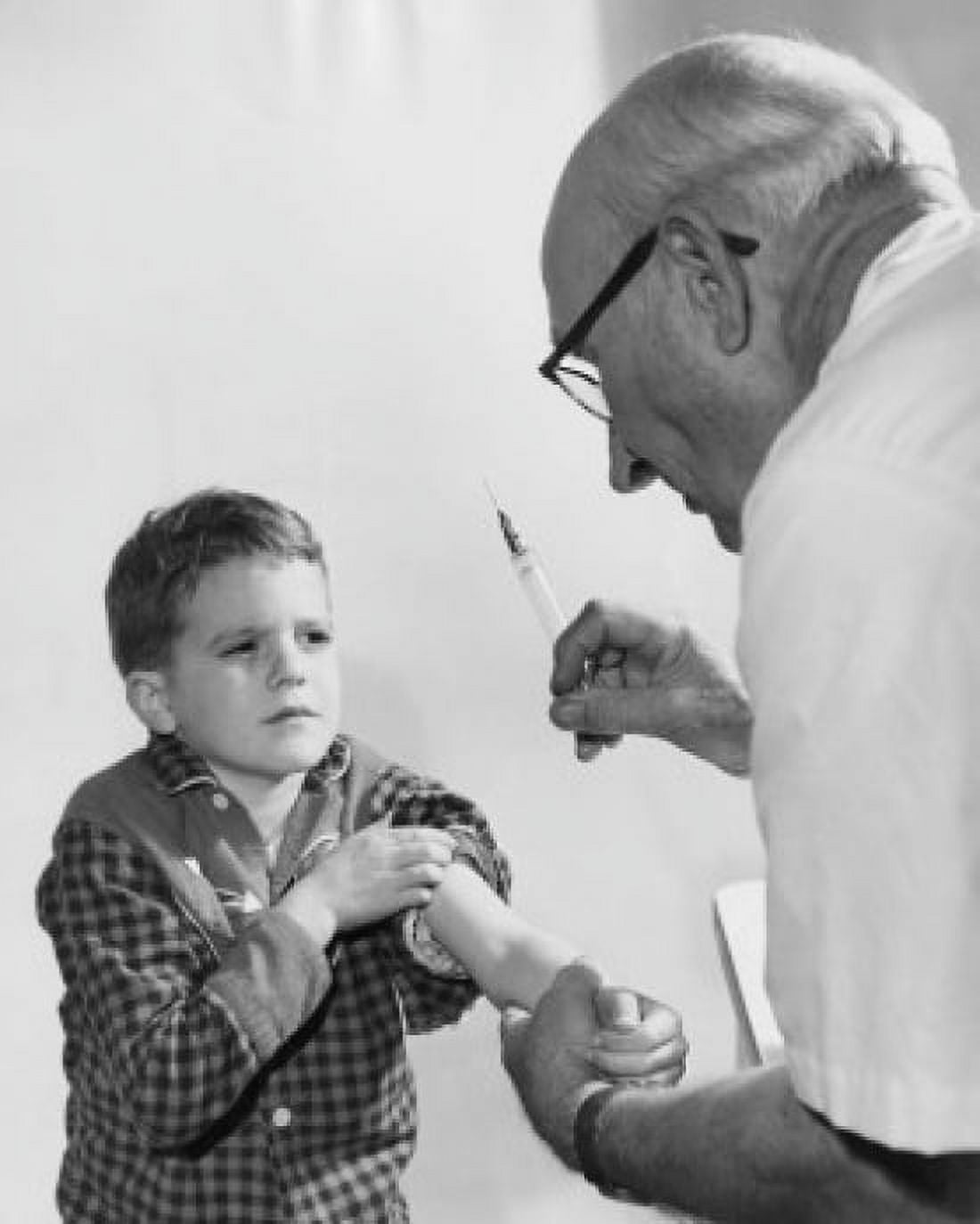 Boy getting an injection from a male doctor Canvas Art - (24 x 36)