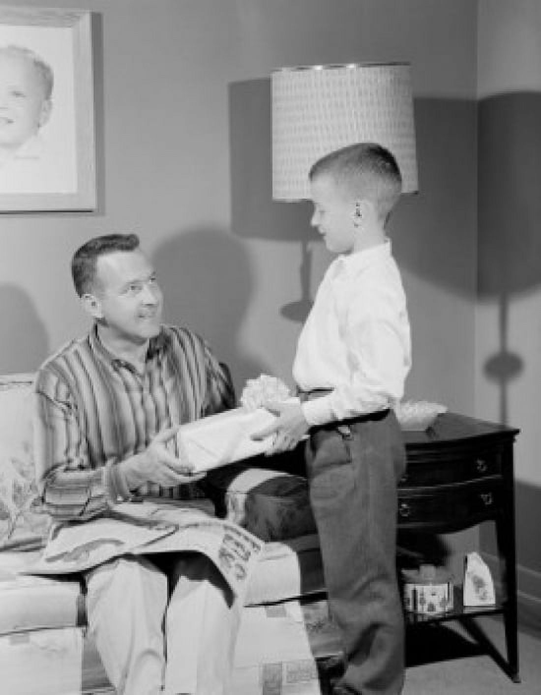 Boy giving gift to father Canvas Art - (24 x 36)