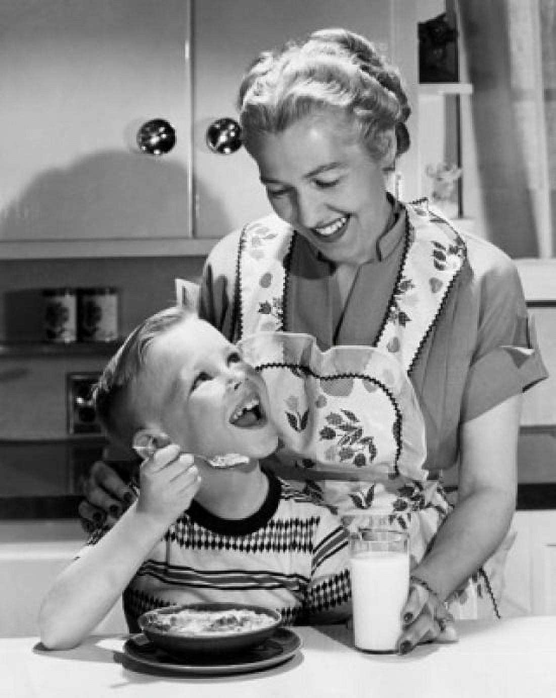 Boy having breakfast with his mother standing behind him Canvas Art - (24 x 36)