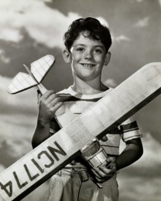 Boy holding a model airplane Canvas Art - (24 x 36)