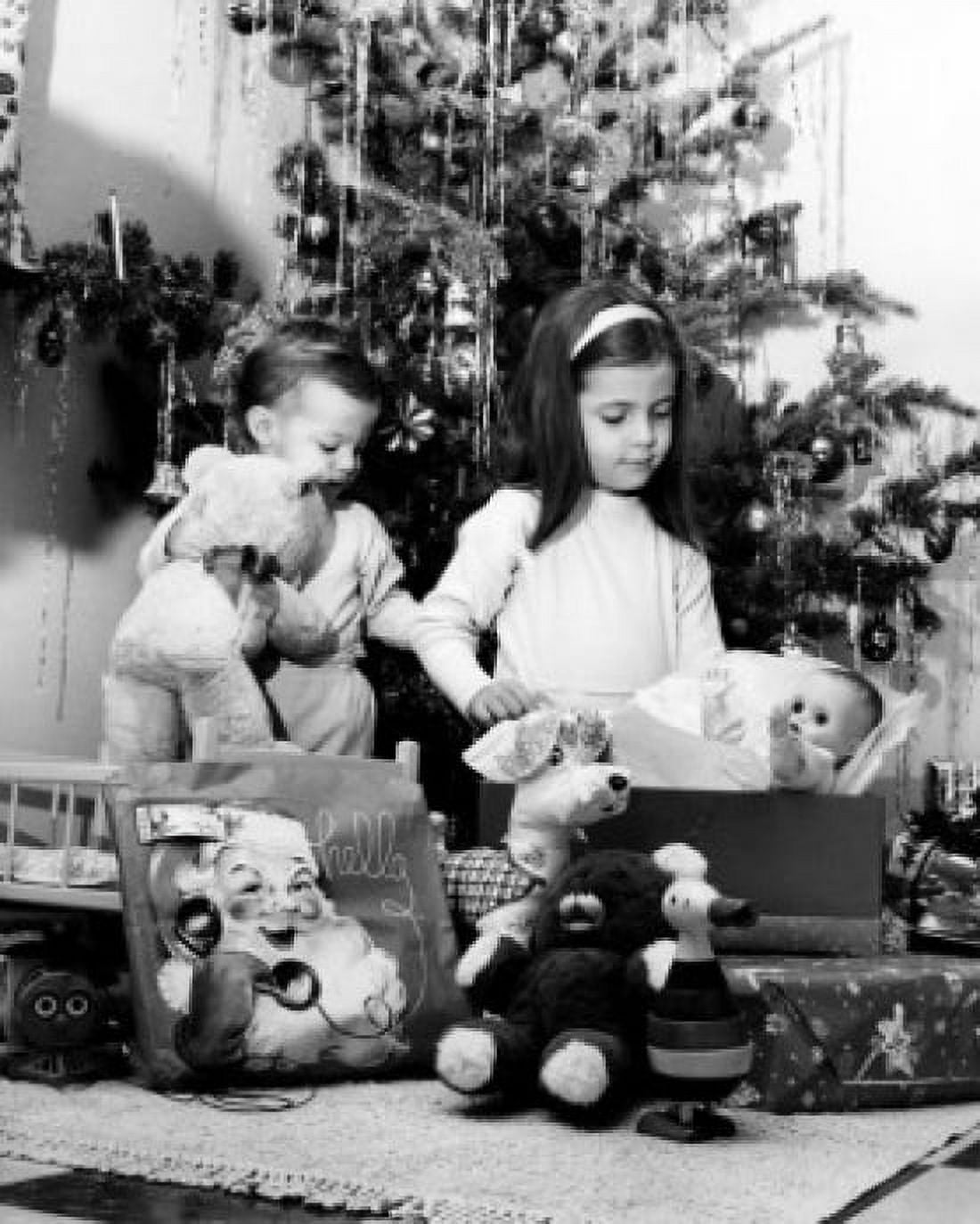 Boy holding a teddy bear and his sister playing with a doll Canvas Art - (18 x 24)