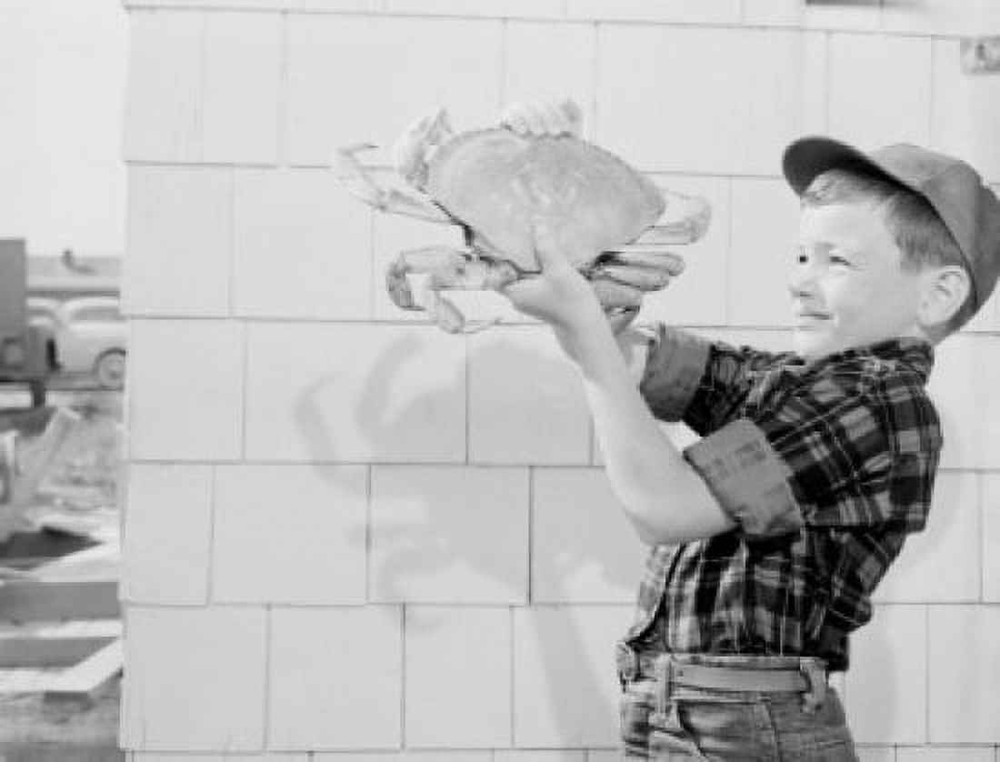 Boy holding big crab Canvas Art - (18 x 24)