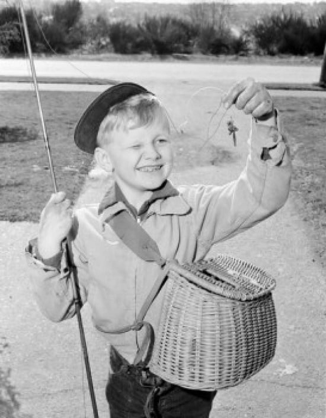 Boy holding fishing bait smiling Canvas Art - (24 x 36)