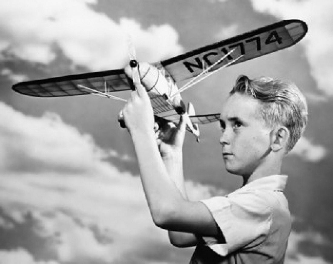 Boy holding model aeroplane Canvas Art - (24 x 36)