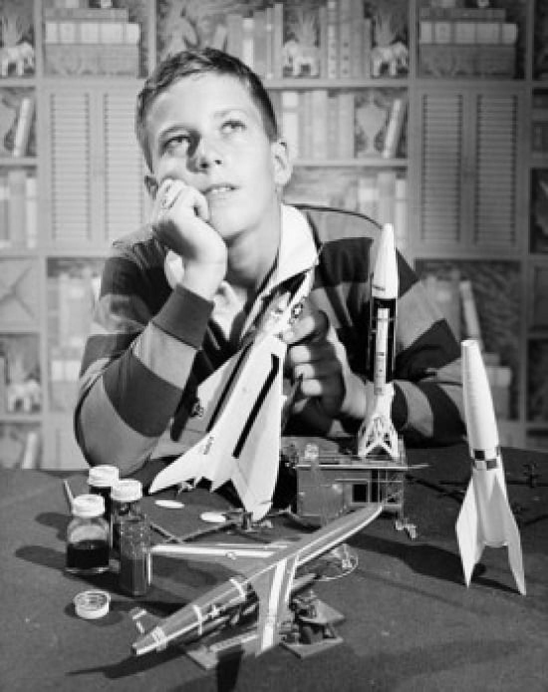 Boy holding model airplane and looking up Canvas Art - (24 x 36)