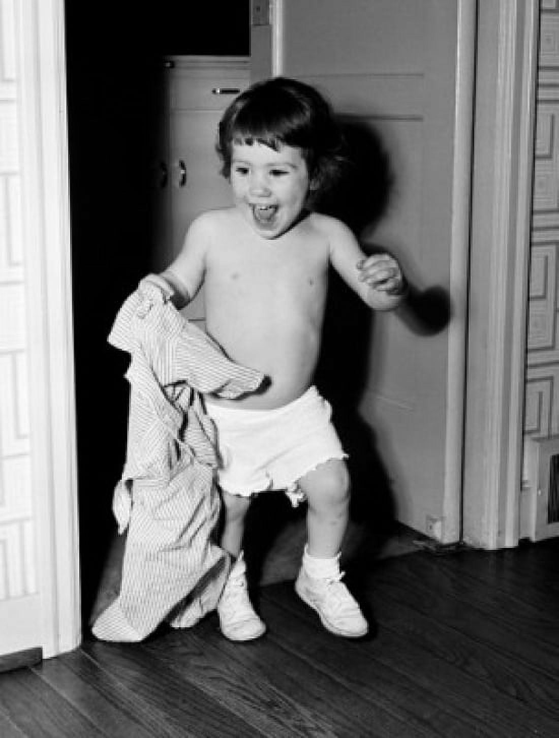 Boy holding shirt in home Canvas Art - (18 x 24)