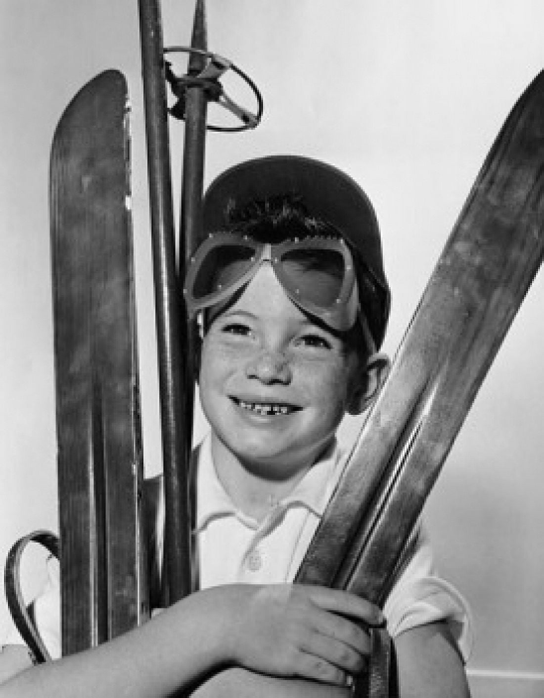 Boy holding skiing equipment Canvas Art - (24 x 36)