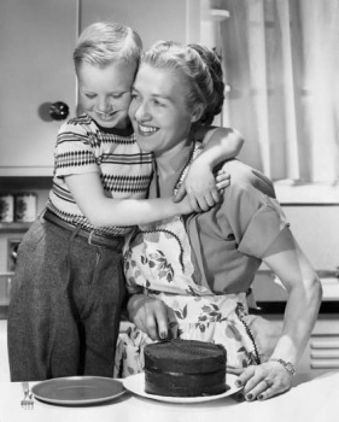 Boy hugging his mother and smiling in front of cake on table Canvas Art - (24 x 36)