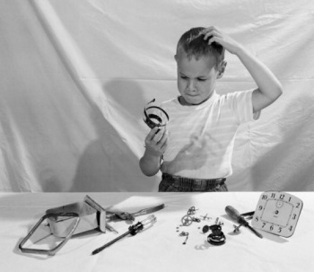 Boy in thoughts holding clocks parts Canvas Art - (24 x 36)