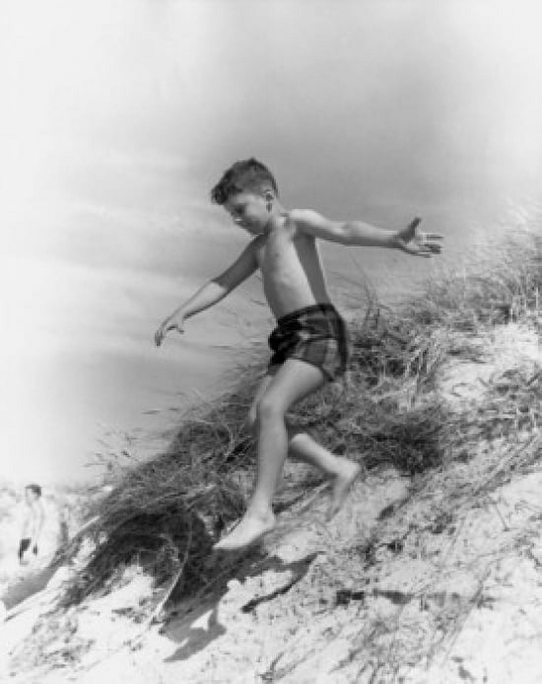 Boy jumping from sand dune Canvas Art - (18 x 24)