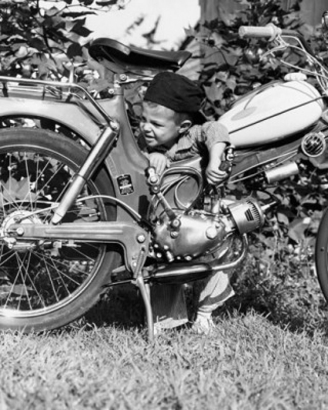Boy leaning on moped Canvas Art - (24 x 36)