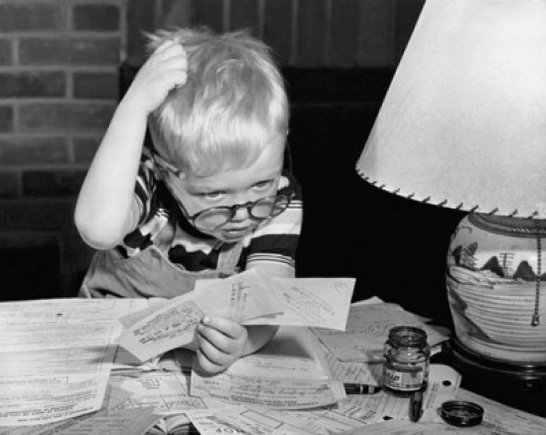 Boy looking at bills and scratching his head Canvas Art - (24 x 36)
