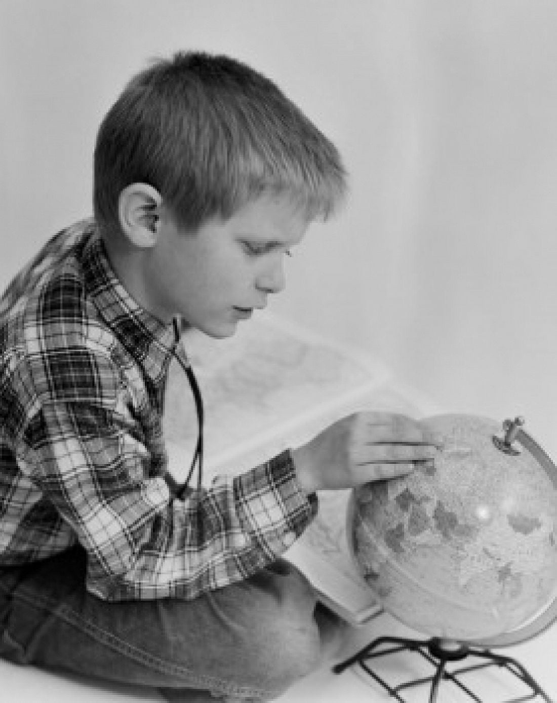Boy looking at globe Canvas Art - (24 x 36)