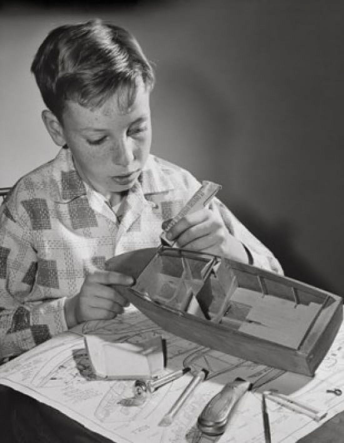 Boy making a model of a boat Canvas Art - (18 x 24)