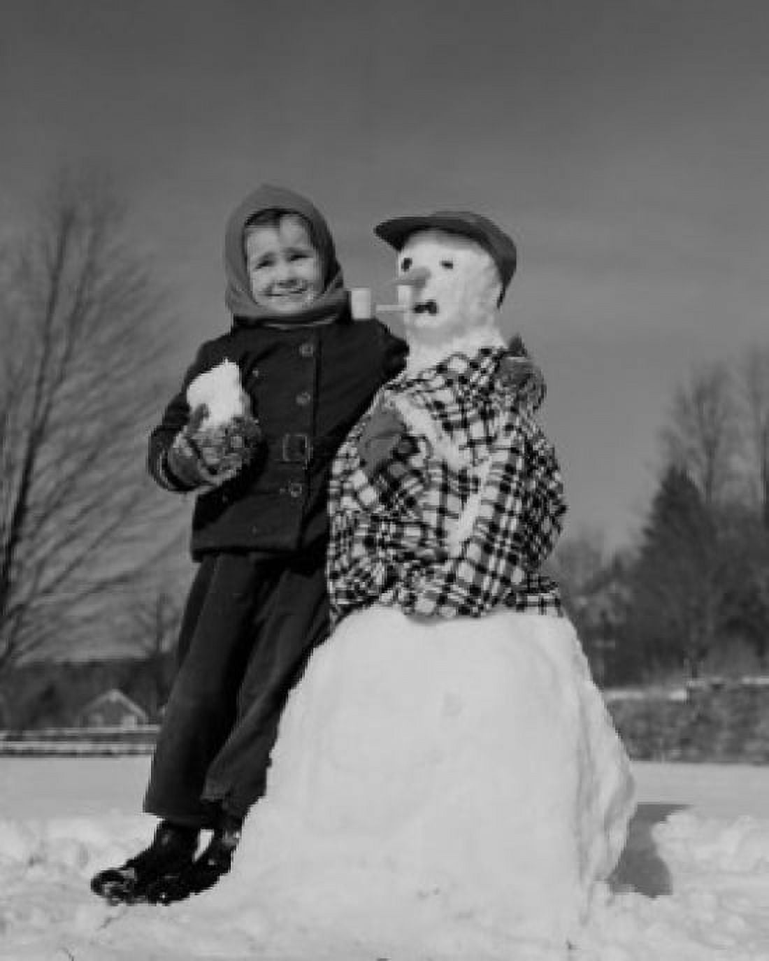 Boy making snowman Canvas Art - (18 x 24)