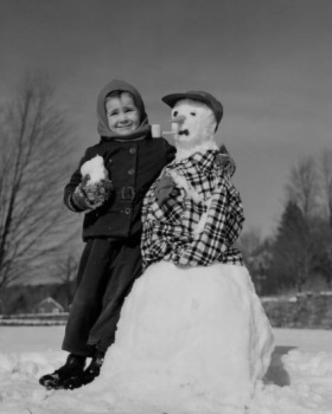 Boy making snowman Canvas Art - (24 x 36)