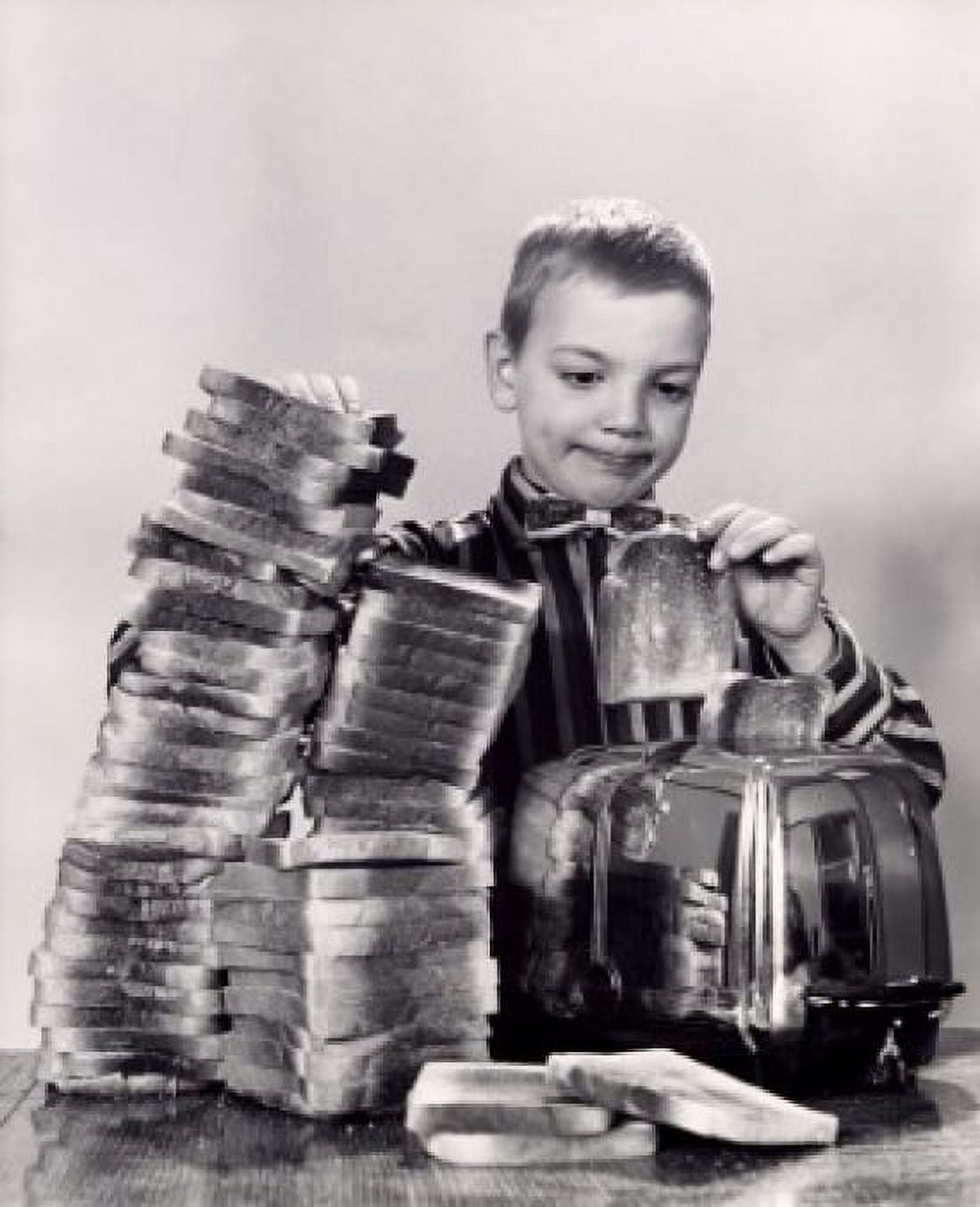 Boy making toast Canvas Art - (24 x 36)