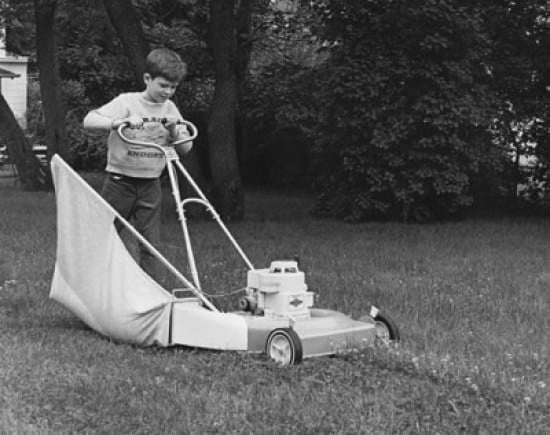 Boy mowing a lawn with a lawn mower Canvas Art - (24 x 36)