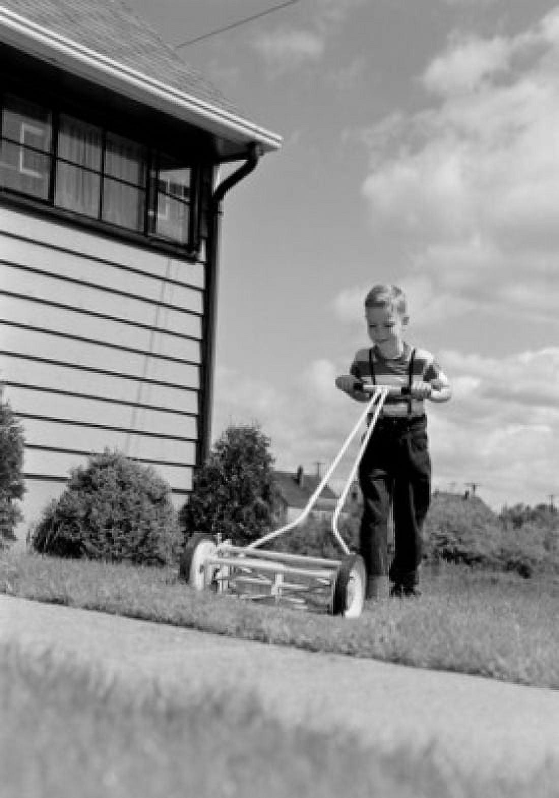 Boy mowing lawn in backyard Canvas Art - (24 x 36)