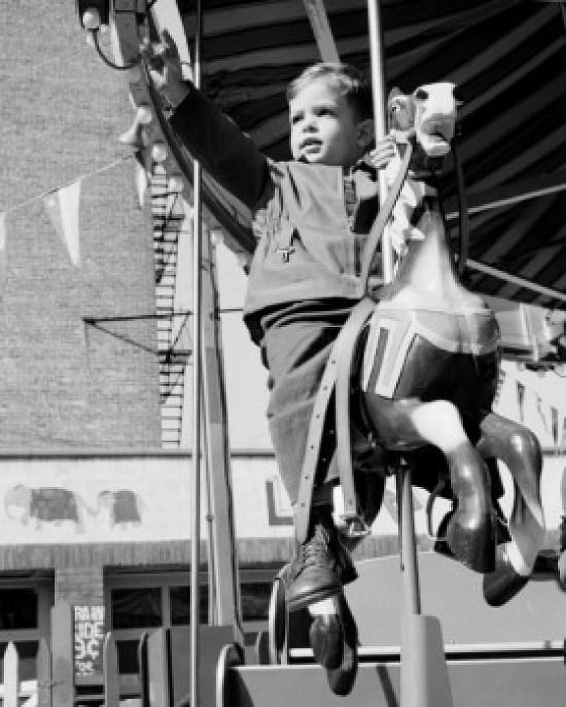 Boy on carousel ride Canvas Art - (24 x 36)