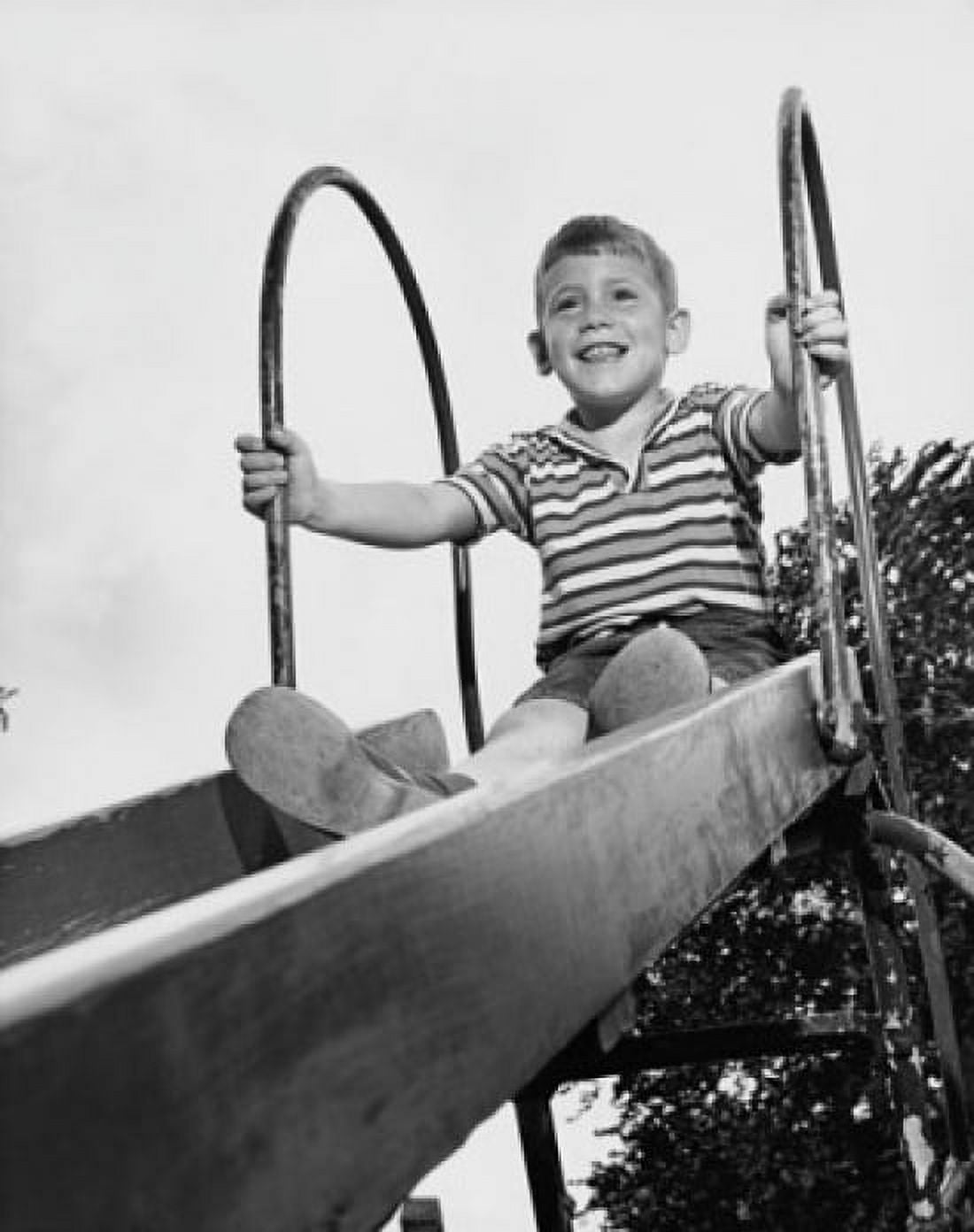 Boy on slide at playground Canvas Art - (24 x 36)