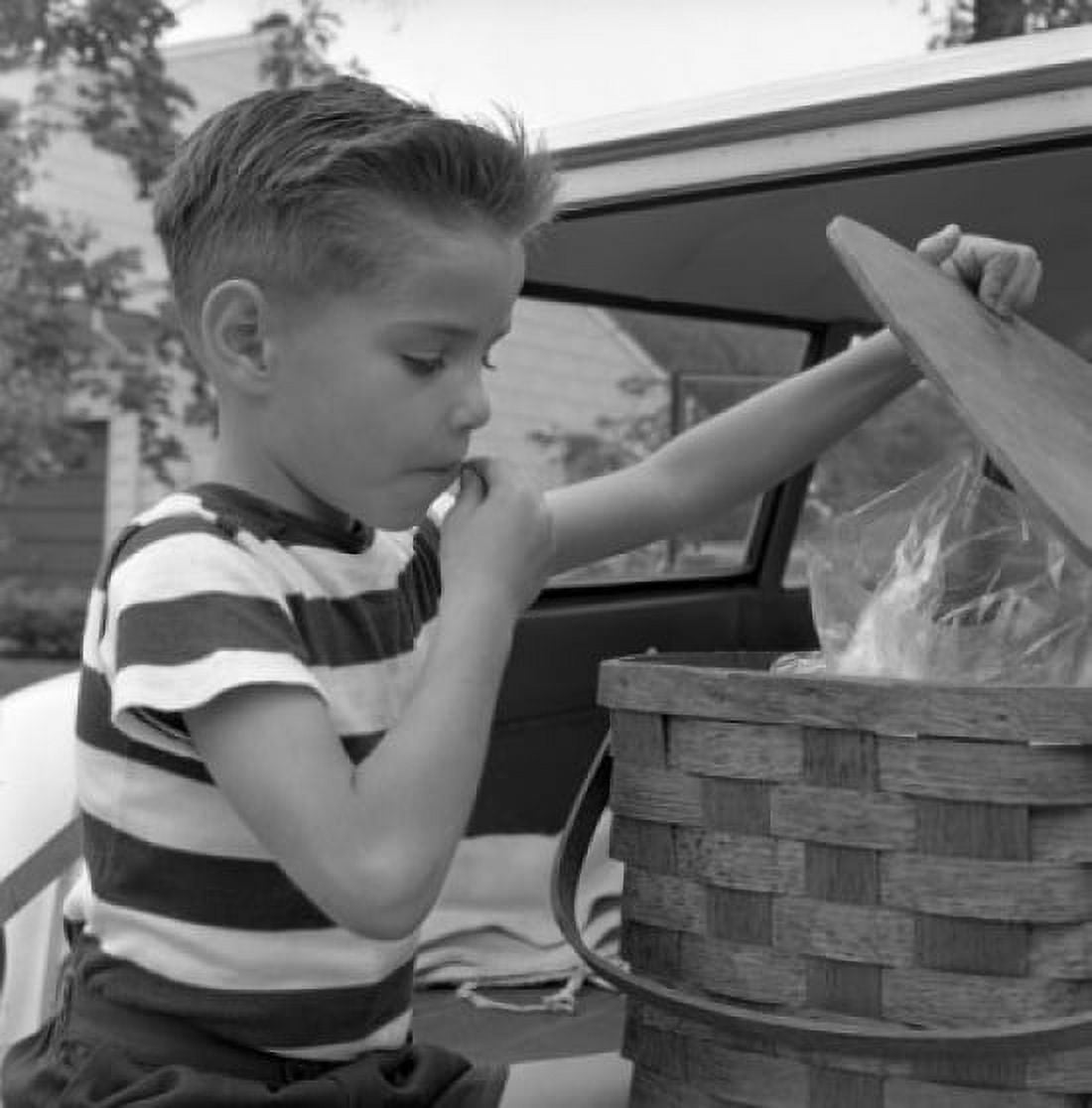Boy opening picnic basket Canvas Art - (18 x 24)