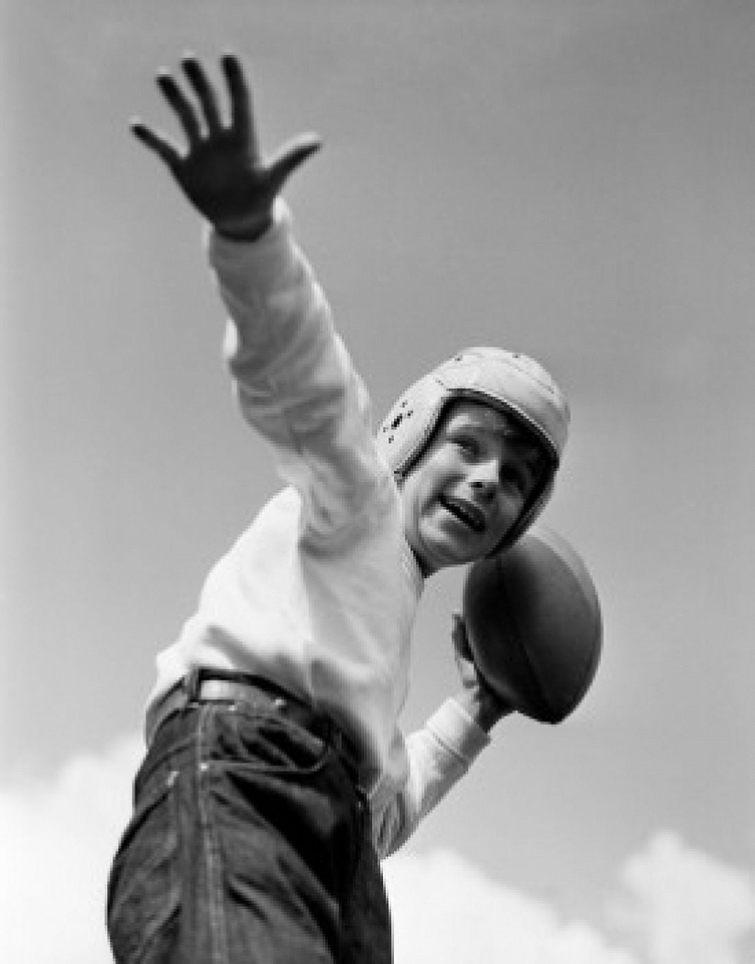 Boy playing American football Canvas Art - (18 x 24)