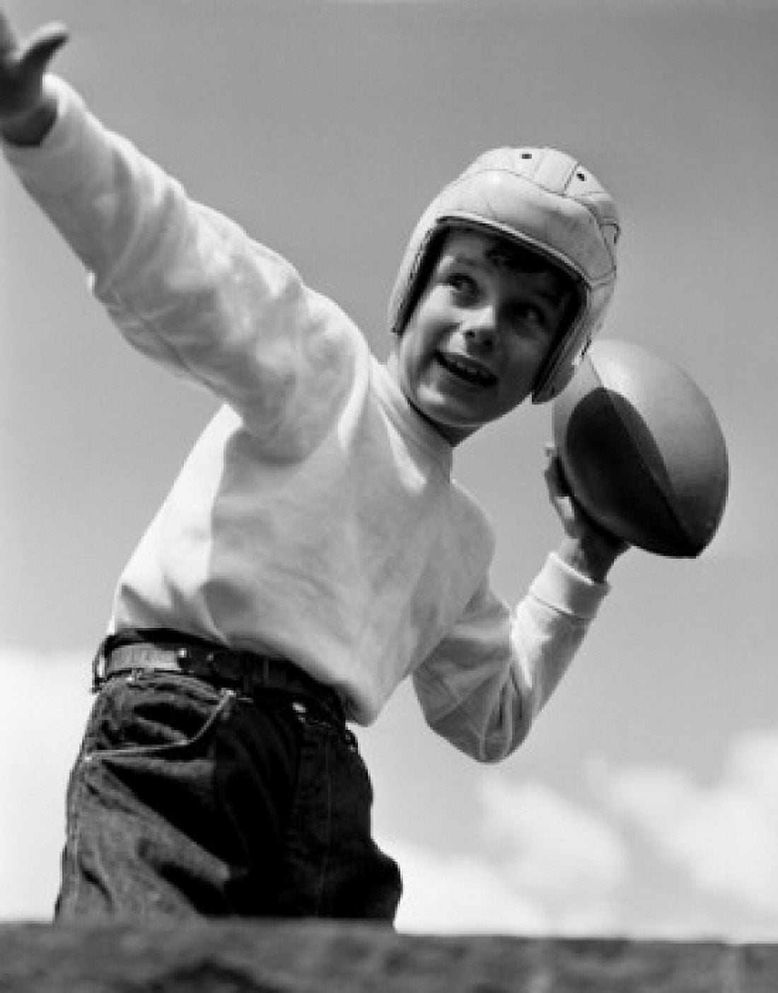 Boy playing American football Canvas Art - (24 x 36)