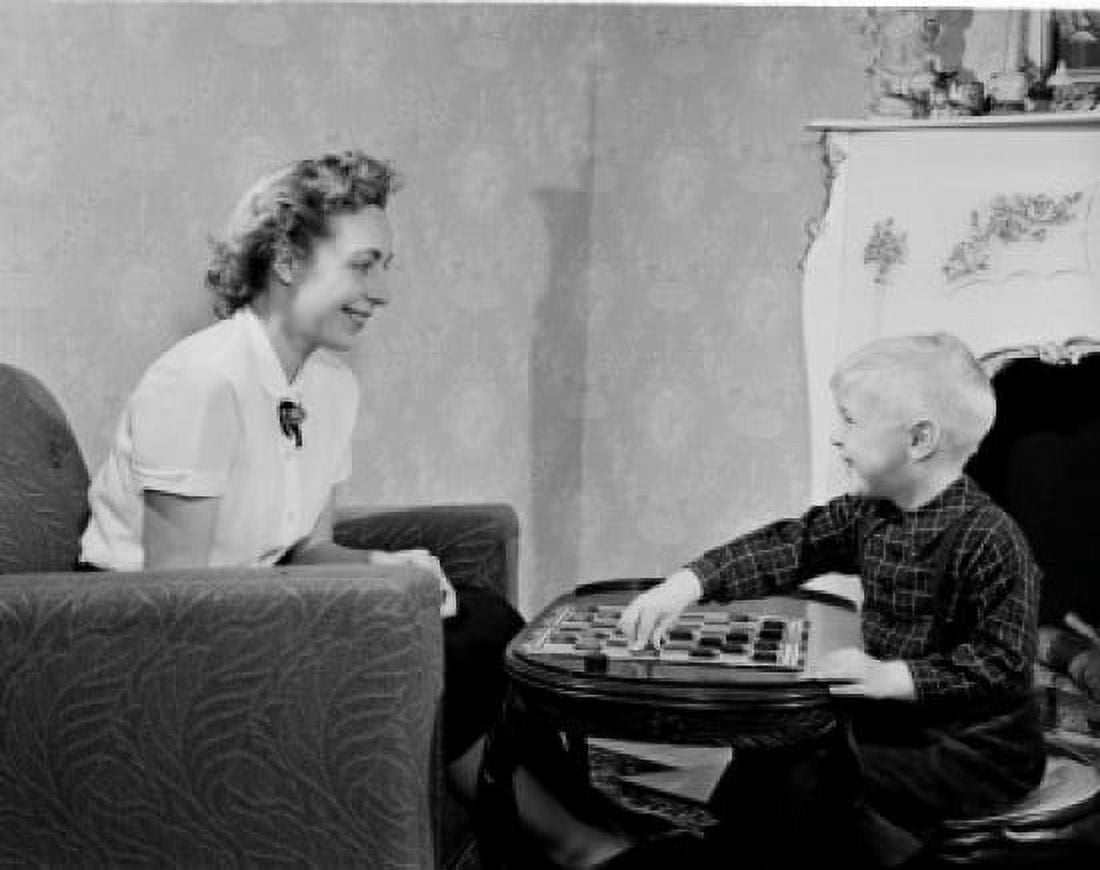 Boy playing draughts with mother in living room Canvas Art - (18 x 24)