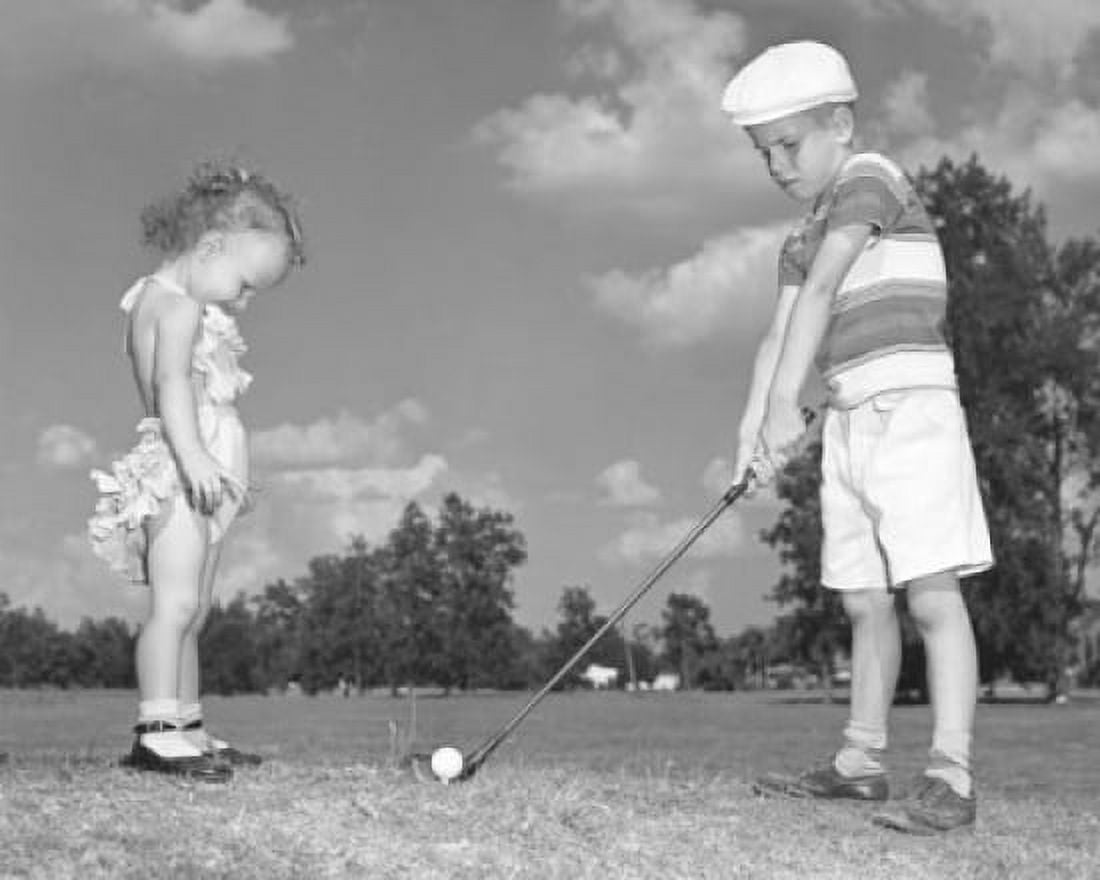 Boy playing golf with his sister standing in front of him Canvas Art - (18 x 24)