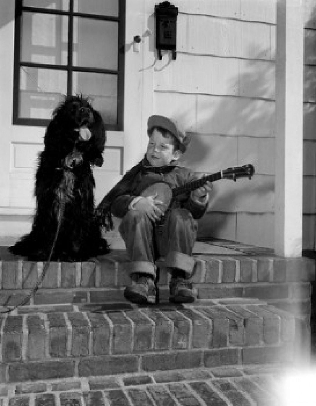 Boy playing on banjo and sitting at steps with dog Canvas Art - (18 x 24)