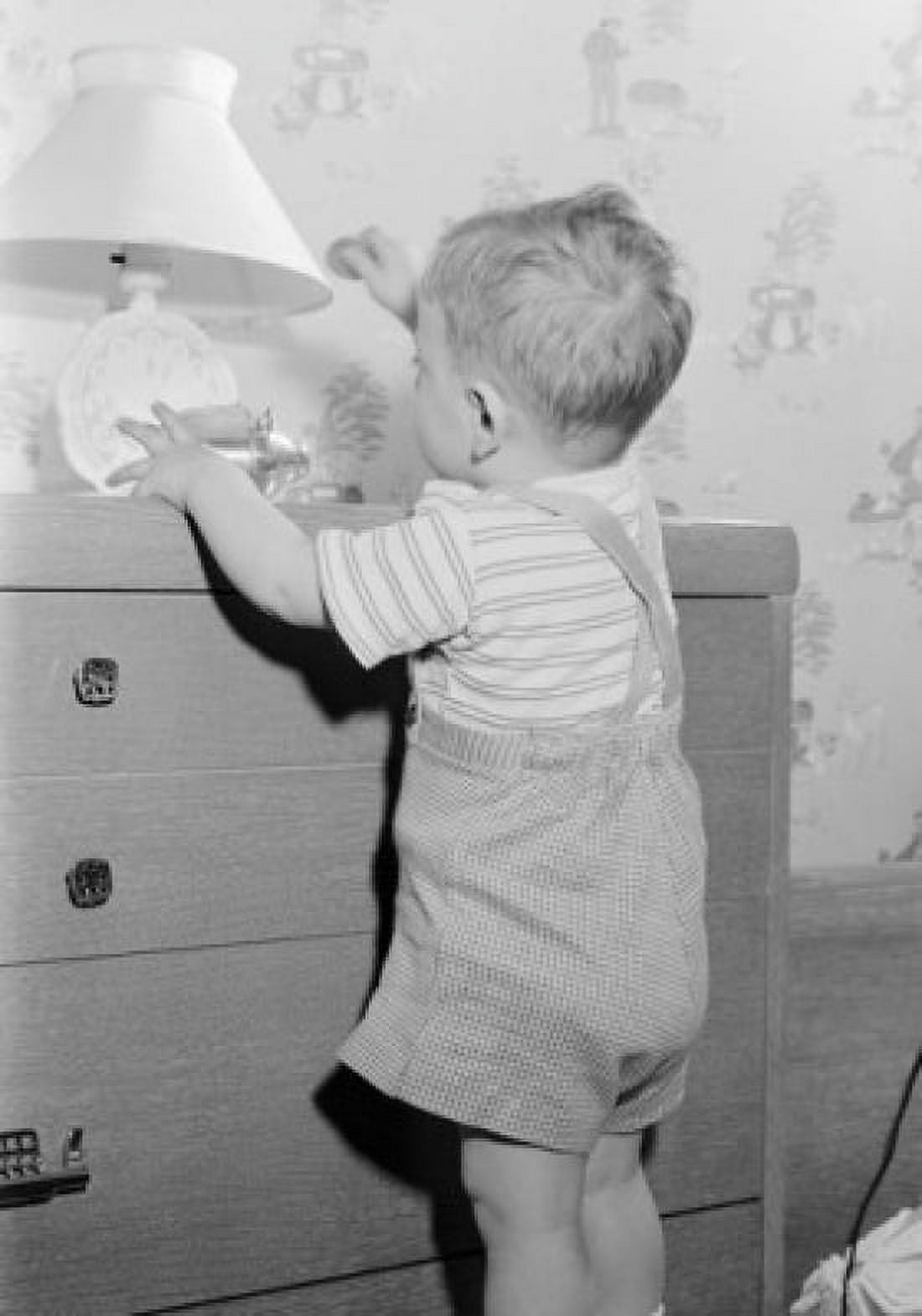 Boy playing on drawer chest Canvas Art - (18 x 24)