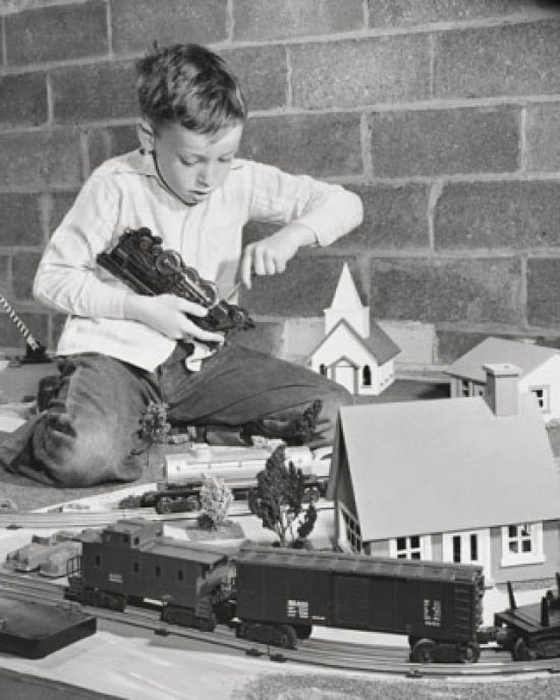 Boy playing with a train set Canvas Art - (24 x 36)
