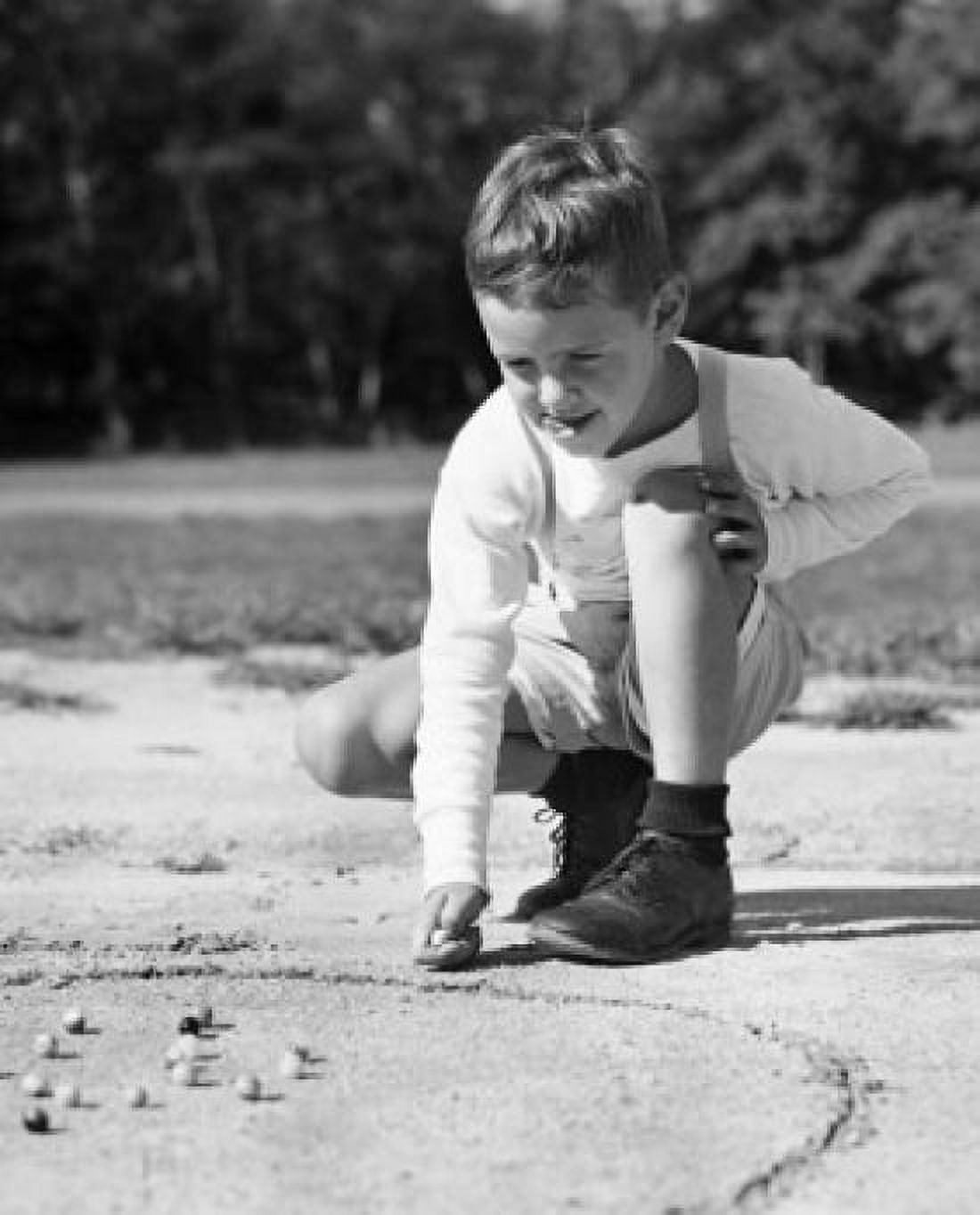 Boy playing with marbles Canvas Art - (24 x 36)