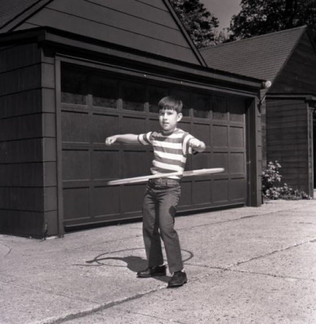 Boy playing with plastic hoop Canvas Art - (24 x 36)