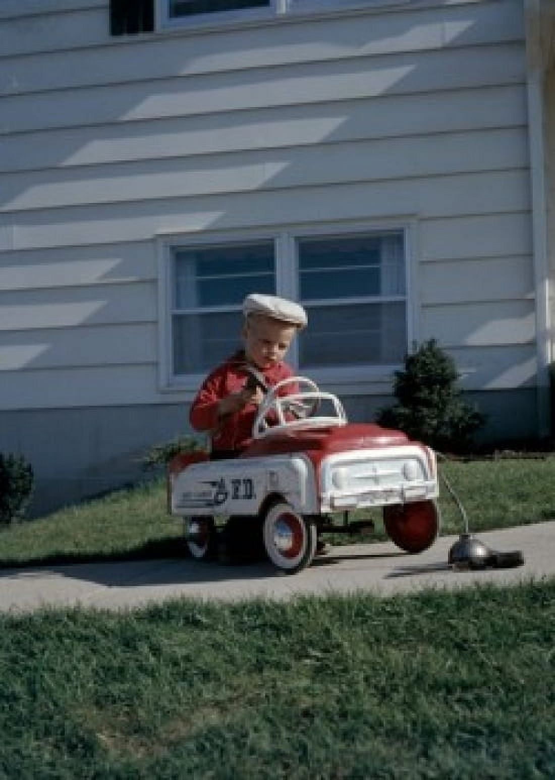 Boy playing with toy car in back yard Canvas Art - (24 x 36)