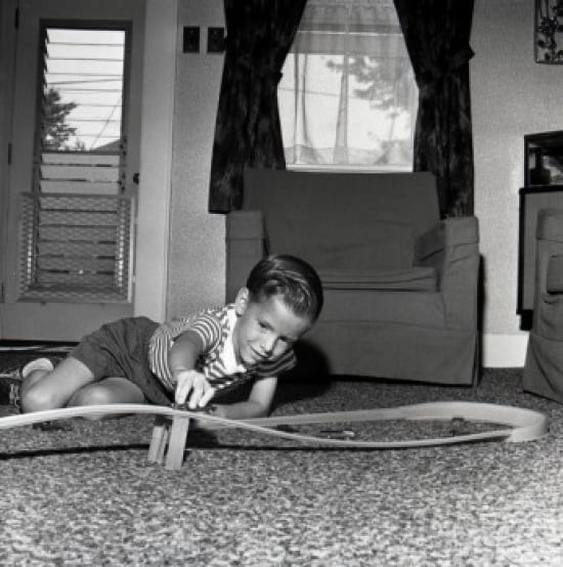Boy playing with toy car on floor Canvas Art - (24 x 36)
