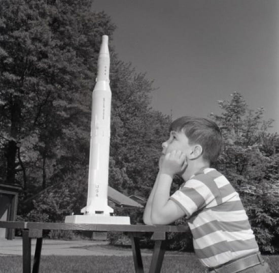 Boy playing with toy rocket Canvas Art - (24 x 36)