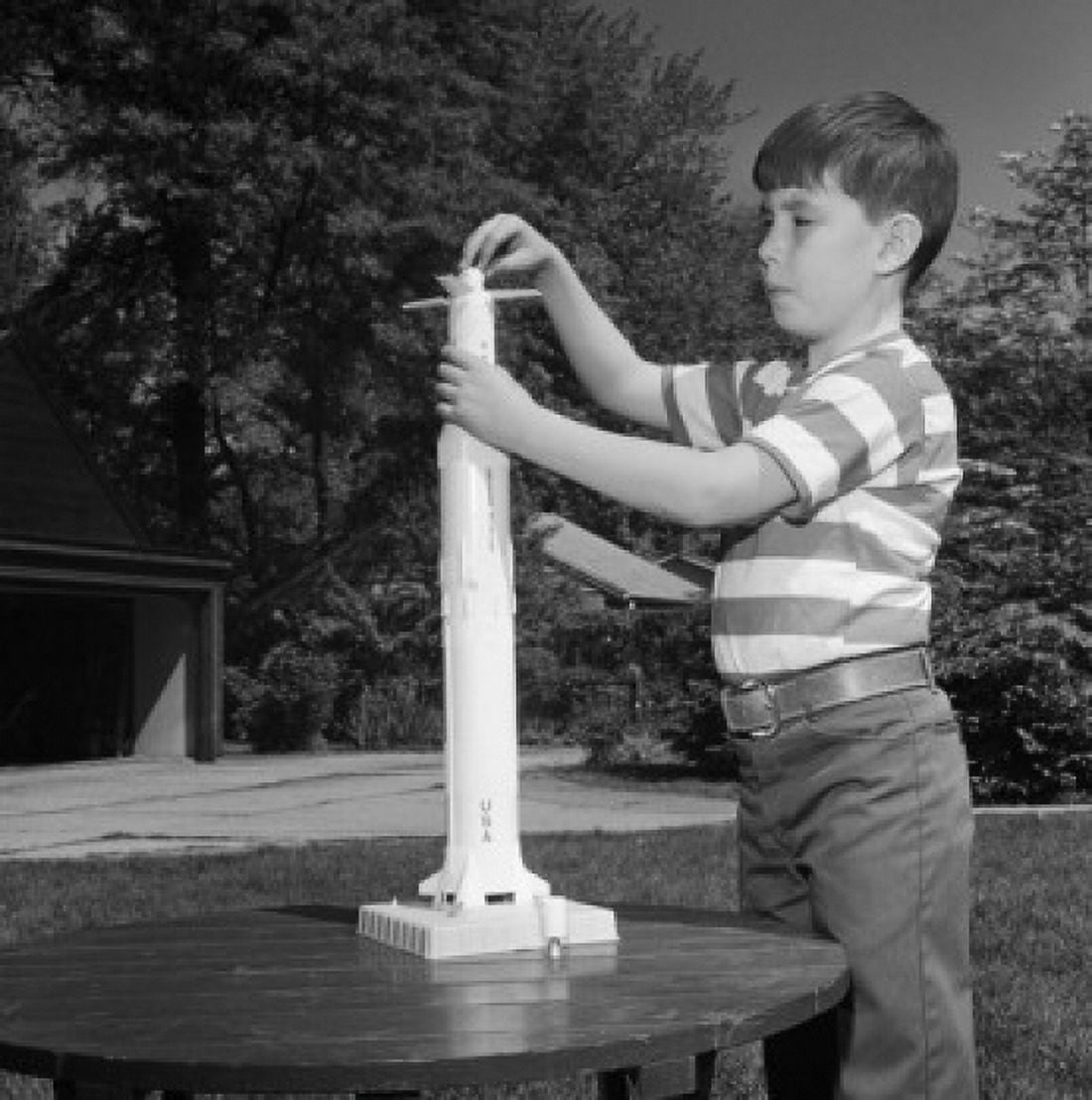 Boy playing with toy rocket Canvas Art - (24 x 36)